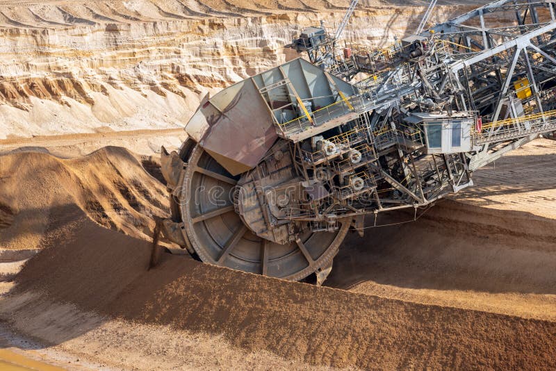 Brown coal open pit landscape with digging excavators in Germany royalty free stock photo