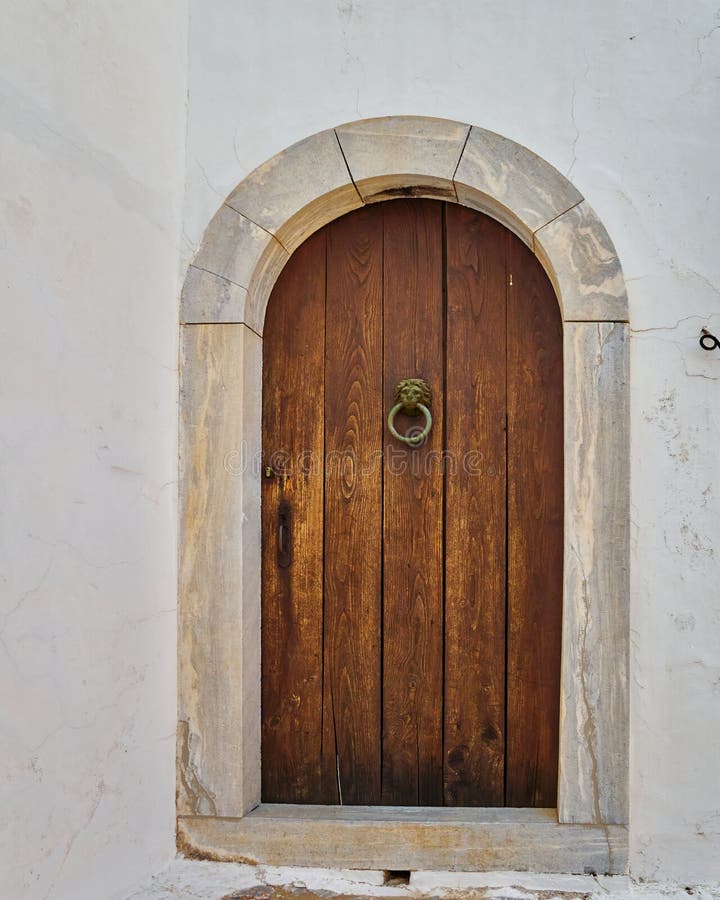 Brown door on white wall stock image. Image of ornament 89805737