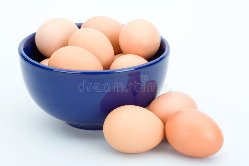 Brown eggs in the blue bowl, isolated