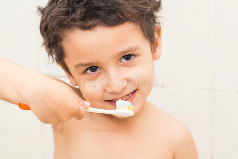 Browneyed Boy Brushing His Teeth in the Bathroom Stock Photo Image