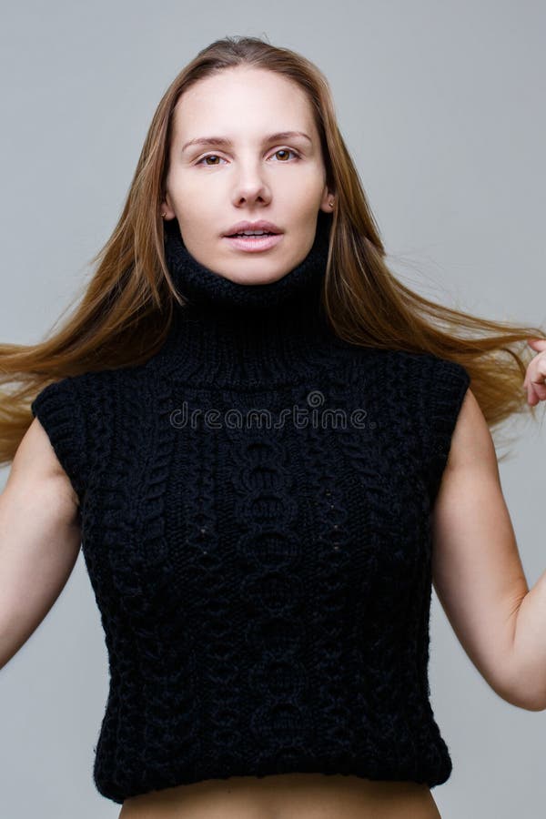 Brown-eyed woman in knitted vest stock images