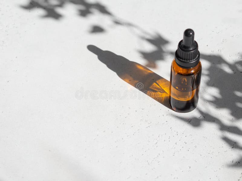 Mockup Of Cosmetic Oil Bottle, Black Pipette Cap, Green Background