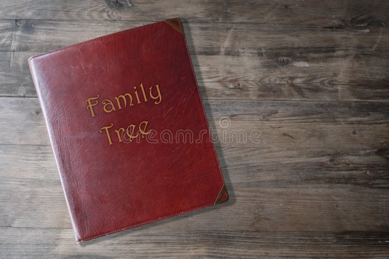 Brown leather board on wooden background, scrapbook family tree in Leather, concept family genealogy, memories, generational ties