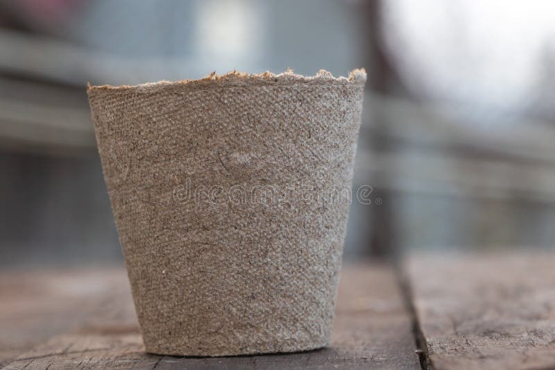 The brown paper cup is made of natural cotton fabric and has the texture of burlap, which can be used as an indoor flower pot or royalty free stock photo