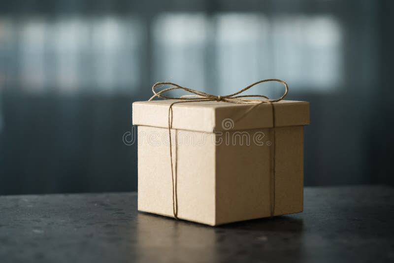 Brown Paper Gift Box On Terrazzo Countertop In Front Of Window