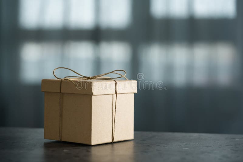 Brown Paper Gift Box On Terrazzo Countertop In Front Of Window