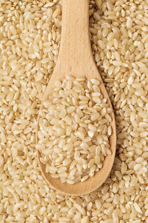 Brown rice and teaspoon stock photo. Image of scoop, thailand 33634040