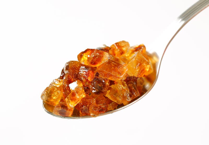 Brown rock sugar on spoon stock image. Image of metal 56805557