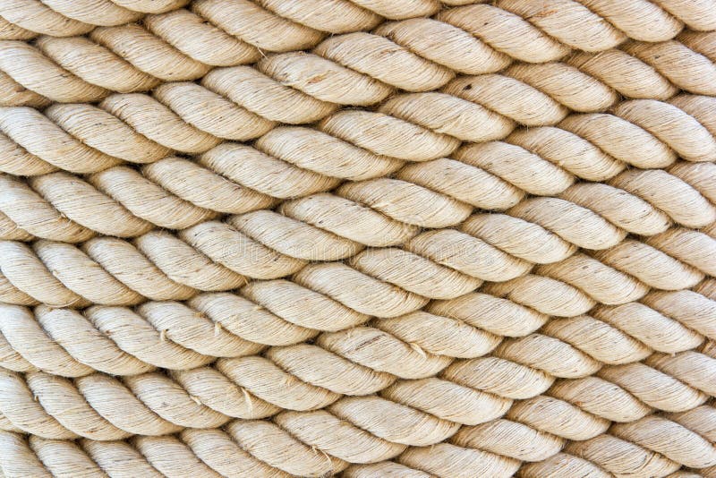 Brown rope bound around a wide post. Tight rope. Keeping together. Holding material stock photo