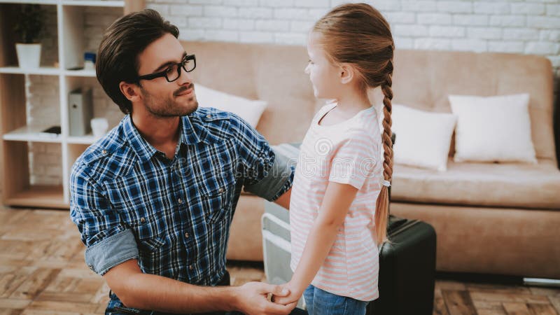 Father and Daughter near Brown Sofa in Apartment. stock photography Father and Daughter near Brown Sofa in Apartment. stock photography