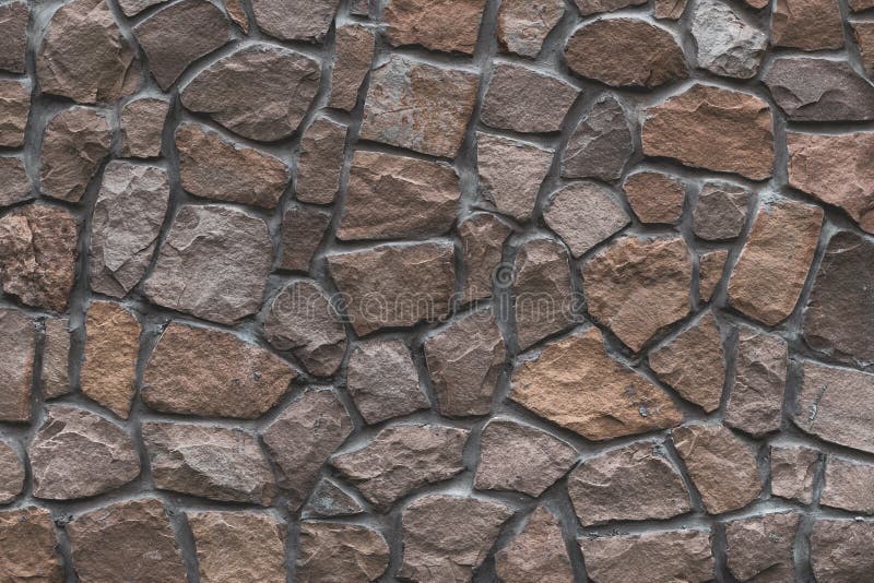 Brown stone texture, retro style. Brick wall background. Abstract rocks pattern. Gray stones, textured surface. Natural backdrop. stock photography