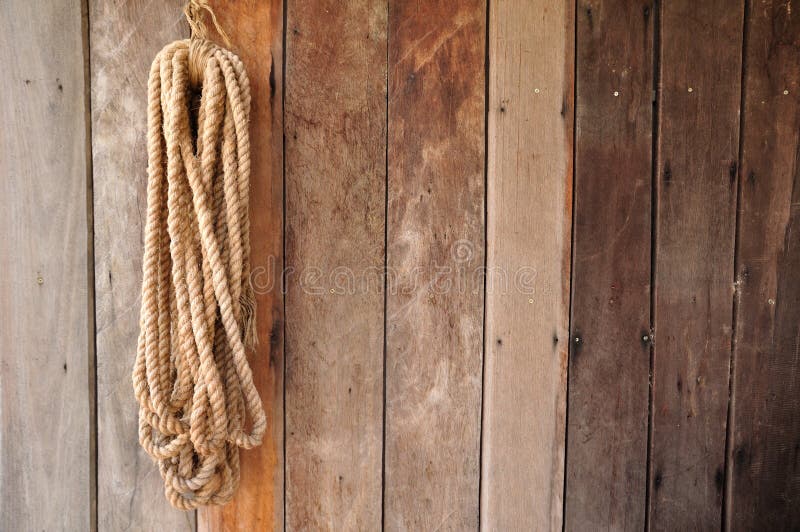 Brown string hanging on wooden wall