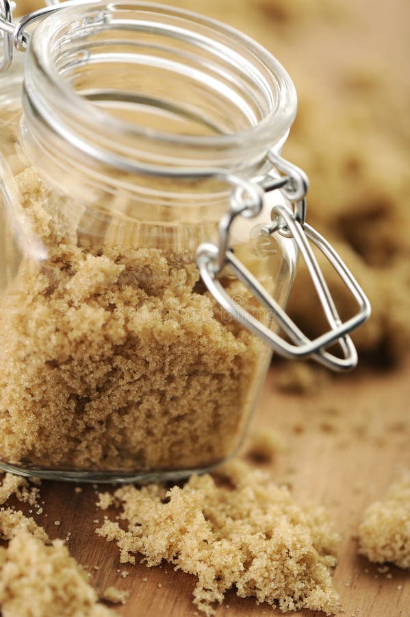 Raw brown sugar in a small jar.