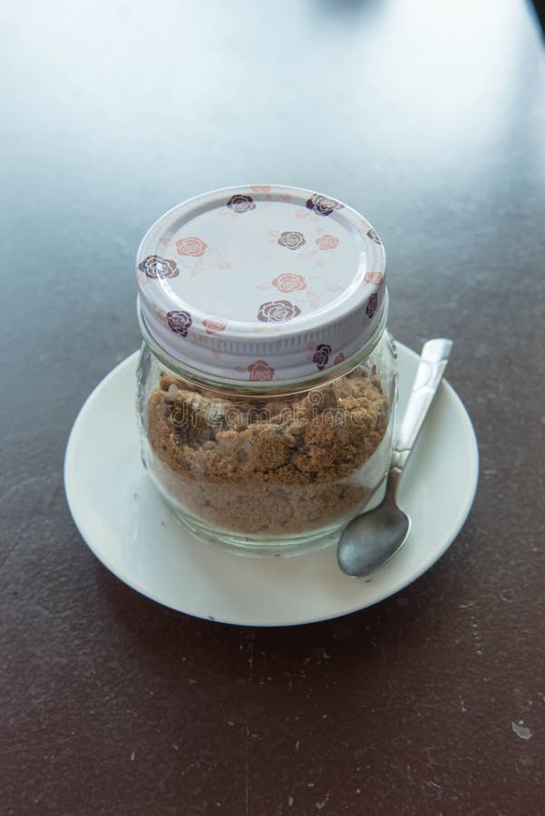 Brown Sugar in Glass Bottles on the Table. Stock Photo Image of glass
