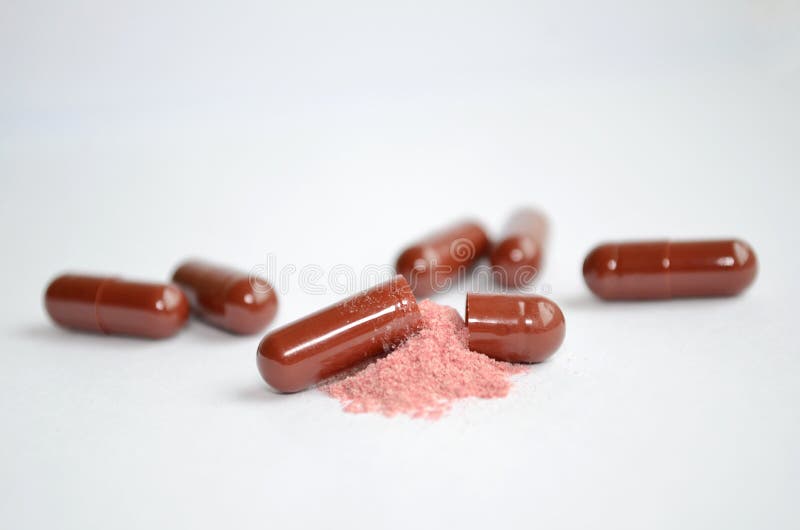 Brown Tablets, Gelatin Capsules, One of Them is Open and with the