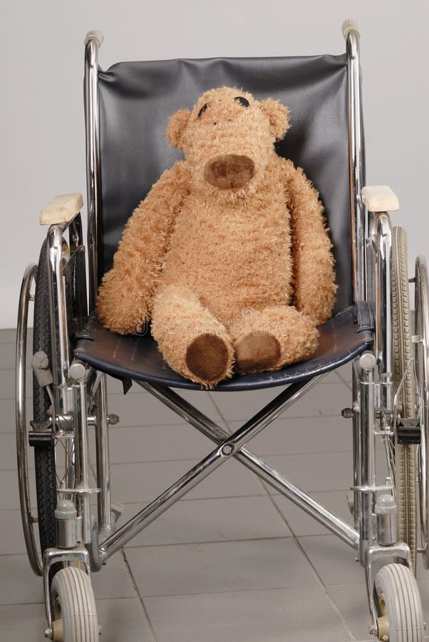 Brown teddy bear in wheelchair