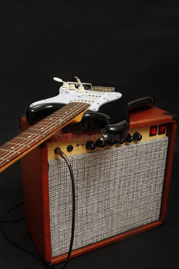 Tube Amplifier for Guitar with Black Guitar, Glass of Beer and Smoking