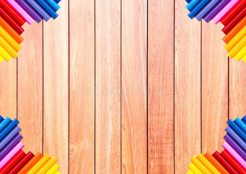 Brown wood plank with colorful pencil at the corner