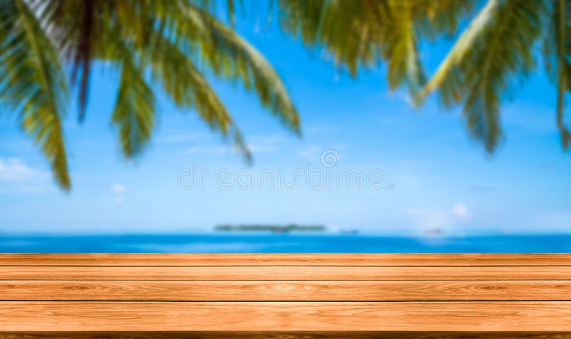 Brown wood table on summer tropical beach.