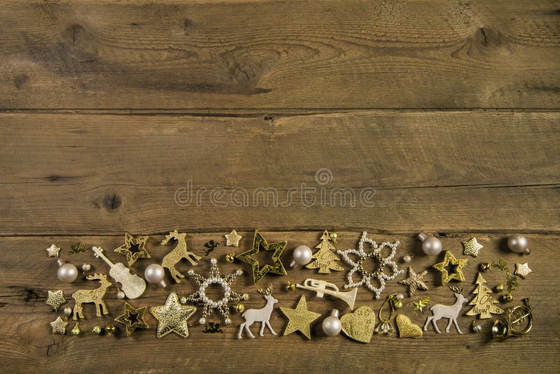 Brown wooden background with golden christmas decoration.