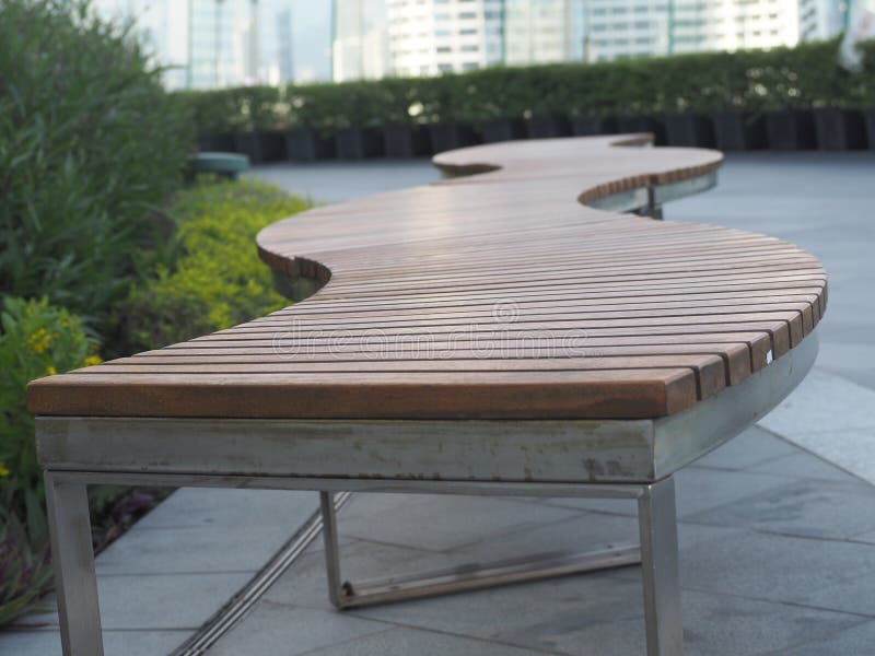Brown Wooden Table on Gray Background Green Leaves Sky Gray White