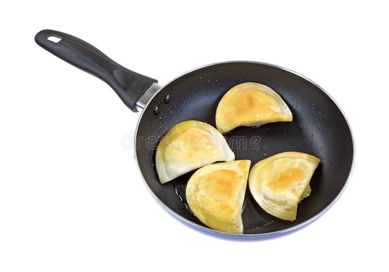 Browned pierogies in a black skillet