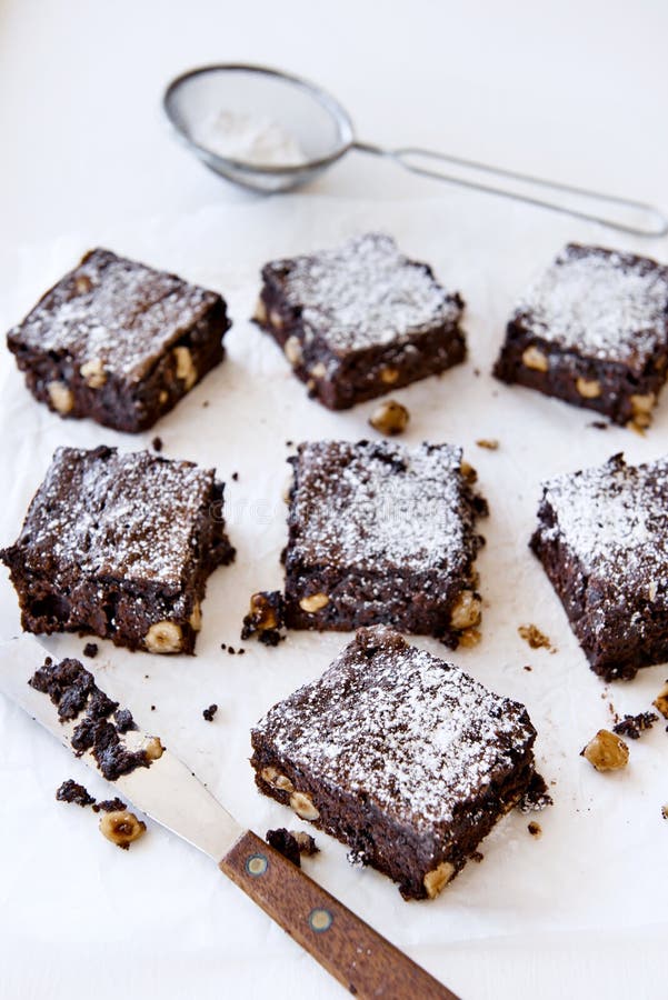 Decadent pieces of cocoa chocolate brownies dessert treat sprinkled with icing sugar. Decadent pieces of cocoa chocolate brownies dessert treat sprinkled with icing sugar