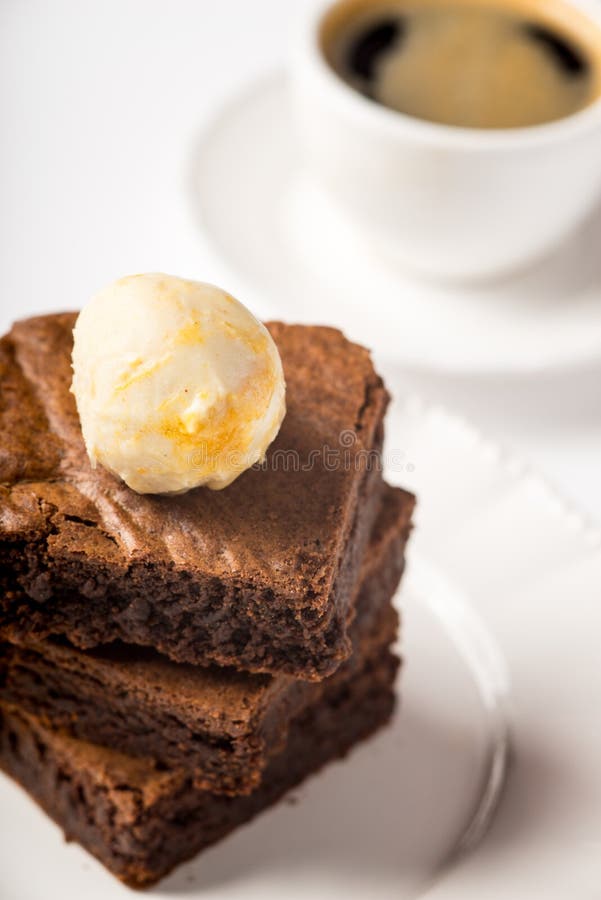 Brownie with Ice Cream and a Cup of Coffee on the Table Stock Photo