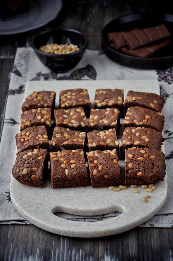 Brownie with Pine Nuts on a Cutting Board. View from Above Stock Photo