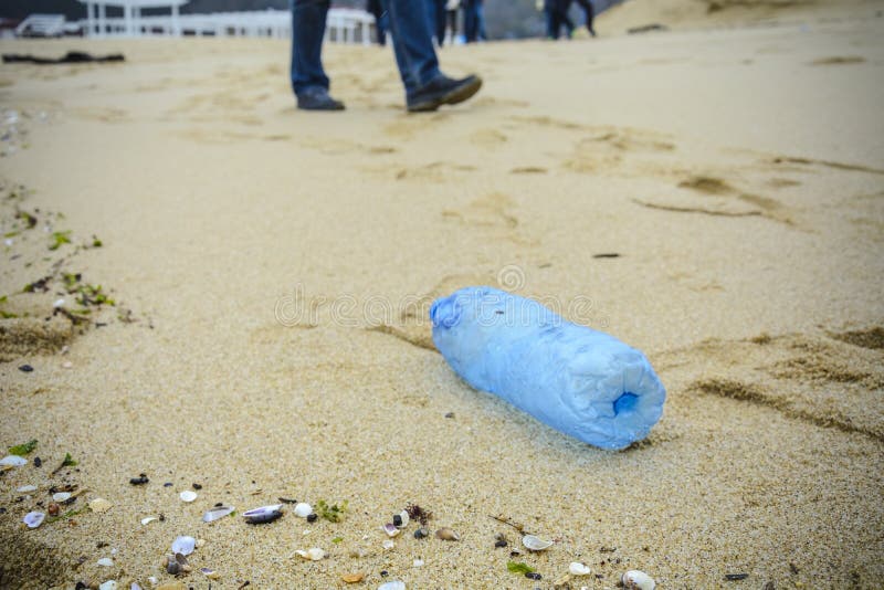 Dirty plastic bottle dropped on the beach. Dirty plastic bottle dropped on the beach