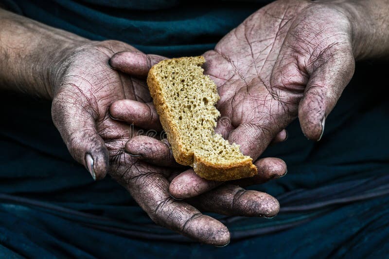 Dirty hands homeless poor man with piece of bread. Dirty hands homeless poor man with piece of bread