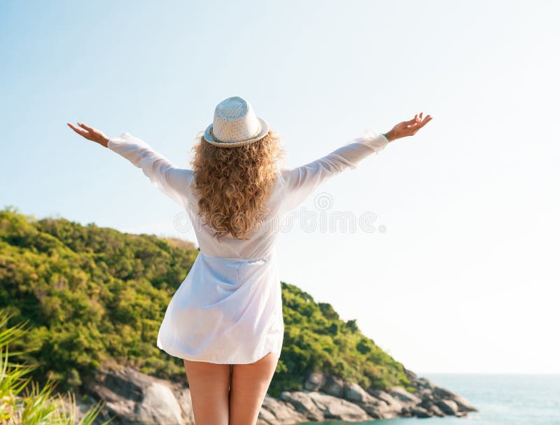 Brune bronz?e soulevant des bras et appr?ciant la libert? par la mer photos libres de droits Brune bronz?e soulevant des bras et appr?ciant la libert? par la mer photos libres de droits