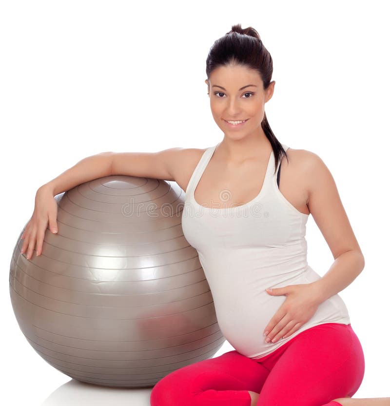 Brunetki kobieta w ciąży z dużą piłką robi exercices obrazy stock Brunetki kobieta w ciąży z dużą piłką robi exercices obrazy stock