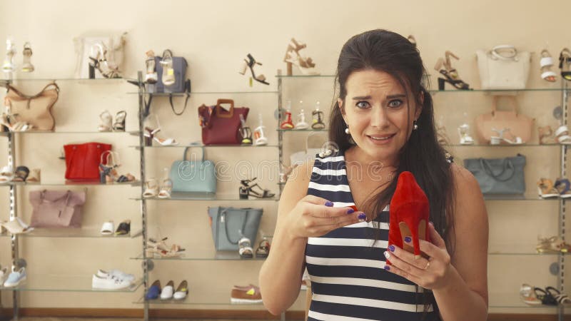 Woman disappointed with shoes price royalty free stock photos Woman disappointed with shoes price royalty free stock photos