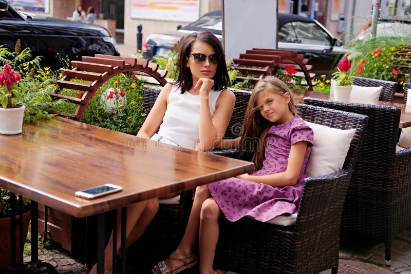 Two girls posing in a cafe.