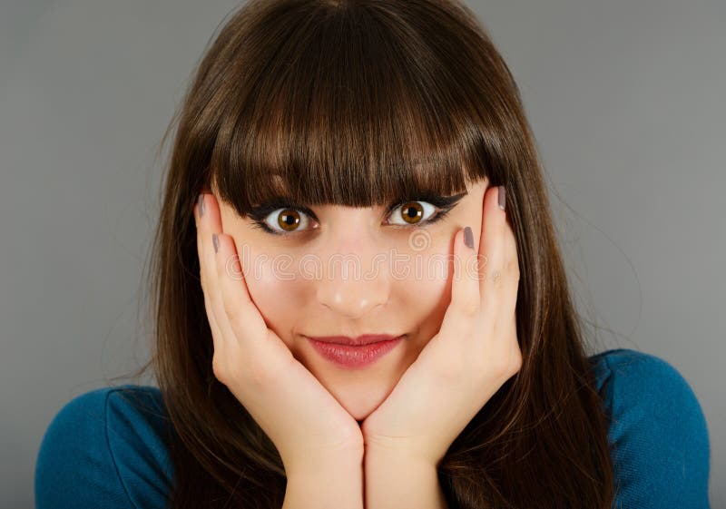 Brunette framing her face with her hands stock photos Brunette framing her face with her hands stock photos