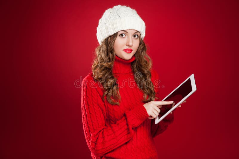 Brunette girl holding ipad touchs screen