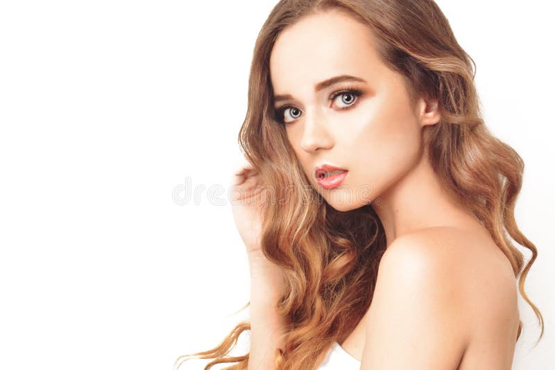 Brunette girl with long and shiny long hair . Beautiful model woman with curly hairstyle and fashionable makeup. royalty free stock images Brunette girl with long and shiny long hair . Beautiful model woman with curly hairstyle and fashionable makeup. royalty free stock images