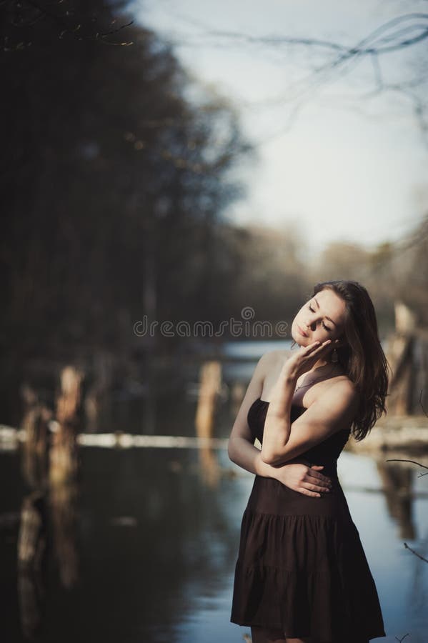 Brunette Girl Stands By The Tree Near The Water Stock Image Image Of