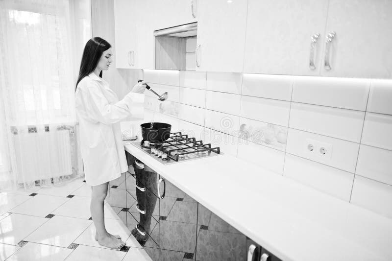 Brunette Girl Wear At Shirt And Underwear Cooking At Kitchen Stock