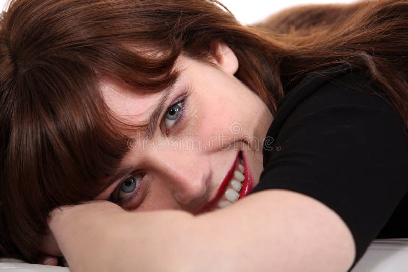 Brunette laying down stock photography