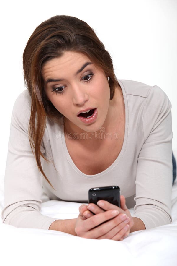 Brunette laying on her bed stock images