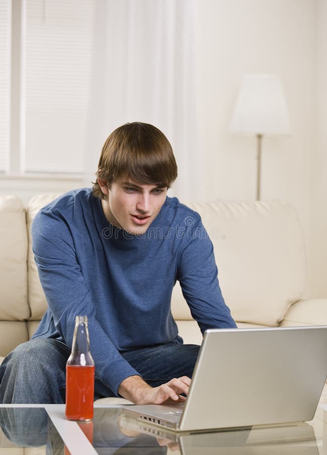 Brunette male using laptop
