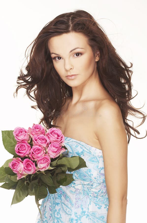 Brunette with pink roses stock photo Brunette with pink roses stock photo