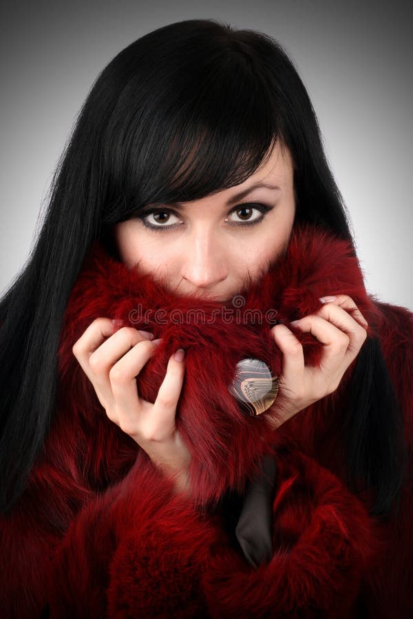 Brunette is in a red fur coat