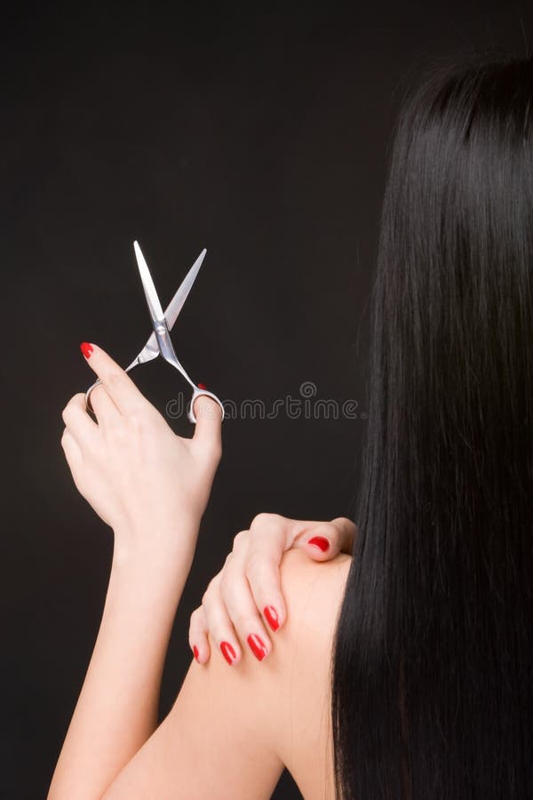 Brunette with scissors of the hairdresser