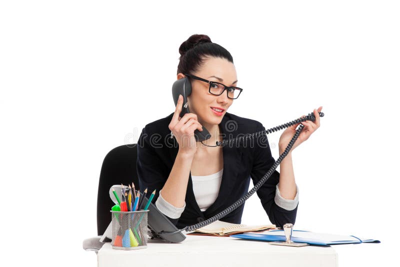 Brunette secretary talking on the phone sitting over table