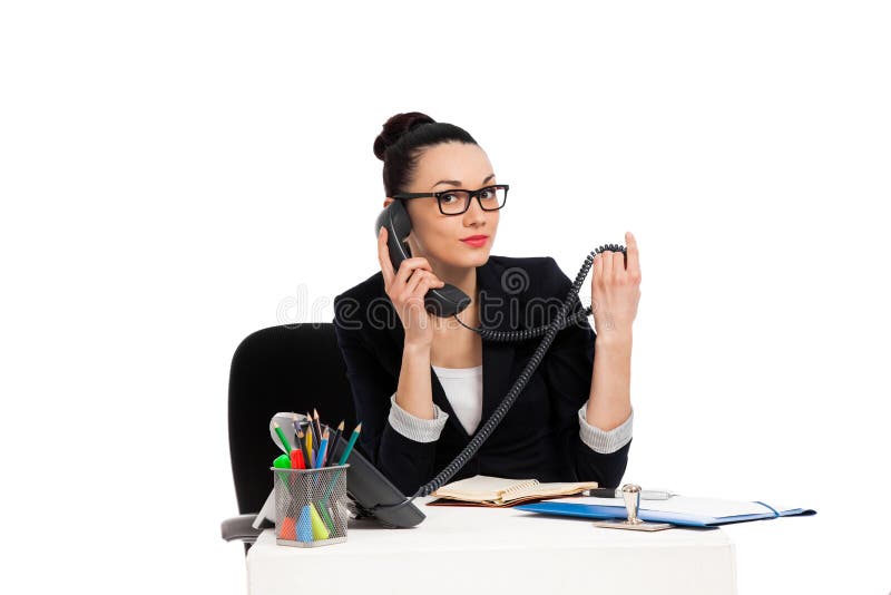 Brunette secretary talking on the phone sitting over table