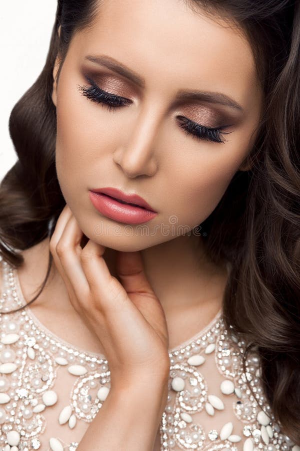 Brunette in Shine Dress with Perfect Makeup, Touching Face. Stock Photo ...