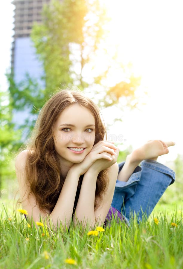 Brunette teenager girl smile on meadow stock image Brunette teenager girl smile on meadow stock image